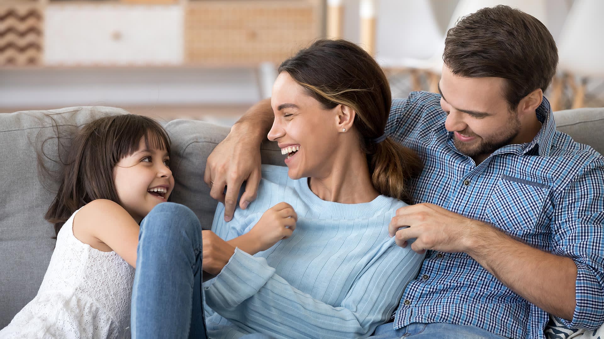 Family relaxing on the couch | Vidrio at Estrella | New homes in Goodyear, Arizona | Landsea Homes