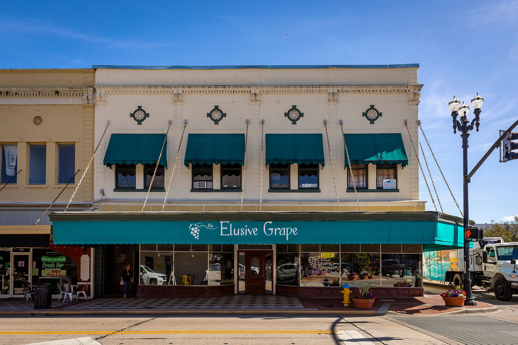 Discover the charm of Downtown DeLand including the Elusive Grape, a cozy winery with fine wines, gourmet bites, and a relaxed atmosphere | New Homes in DeLand, FL | Landsea Homes