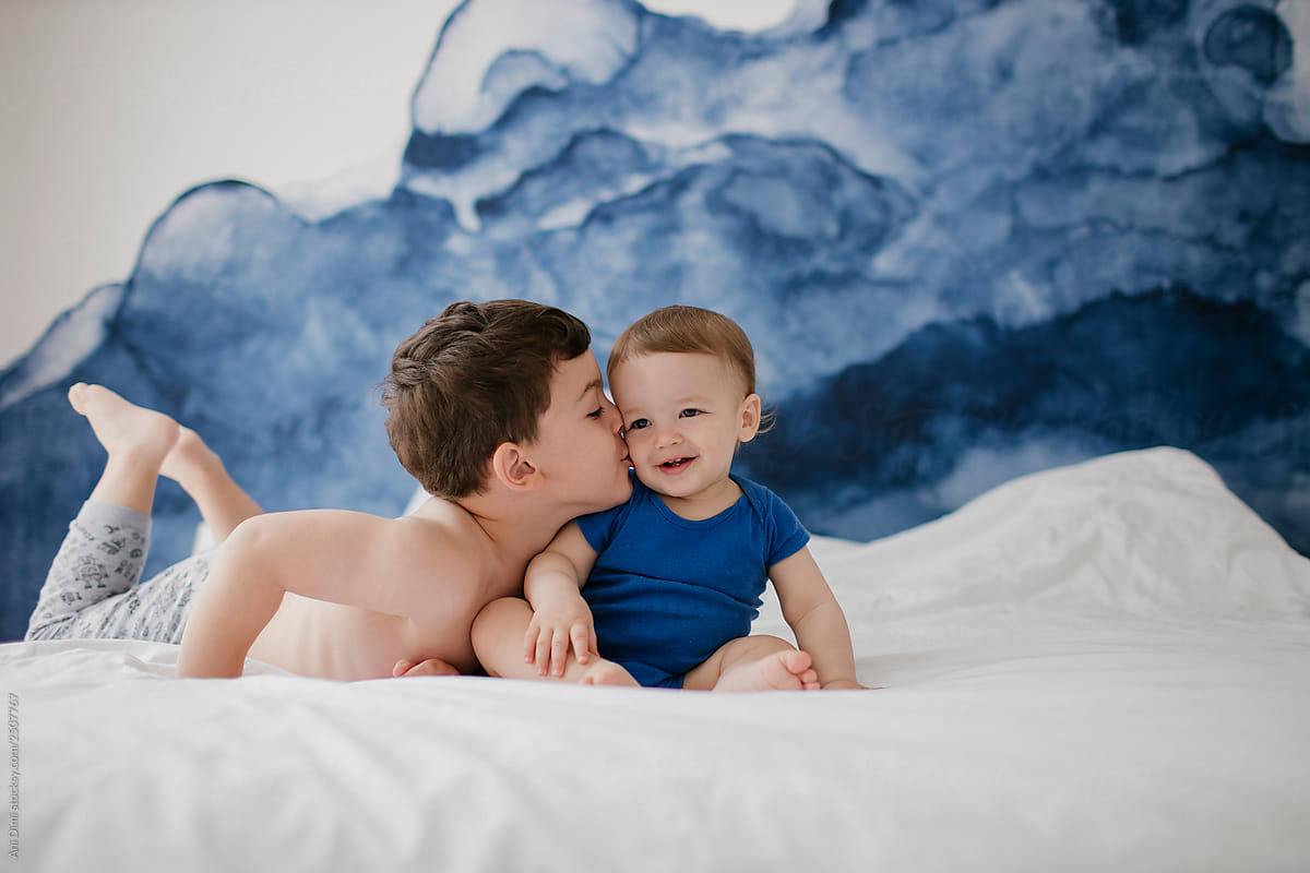 Brother Kissing His Sibling on Cheek
