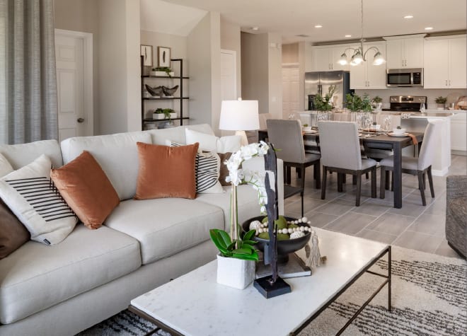 Living, dining, and kitchen main floor of the Hamilton townhome model at Cypress Hammock in Kissimmee, Florida