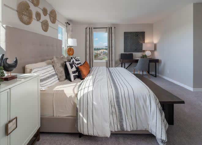 Primary Suite Bedroom of a Townhome in Davenport, Florida, featuring large windows and a queen bed