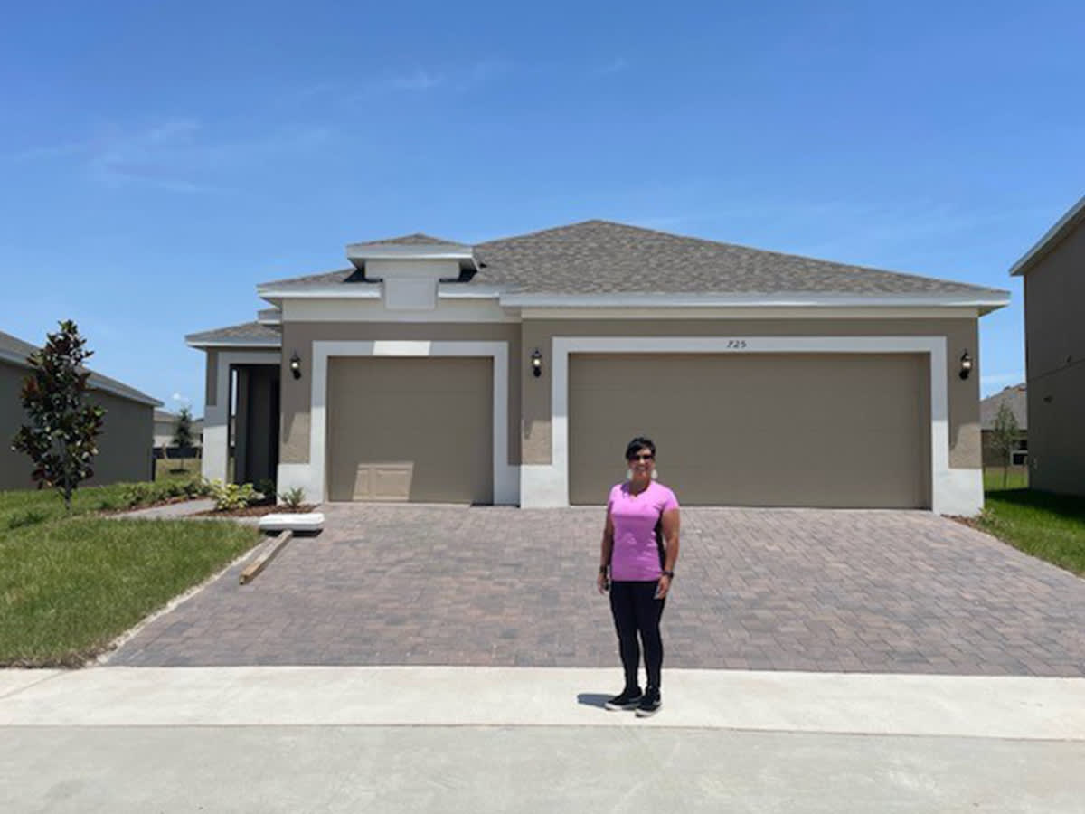 Lourdes Vazquez in front of her new home