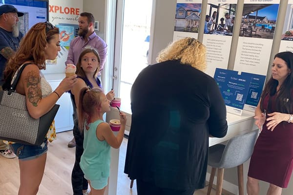 family enjoys ice cream while signing up for community tour