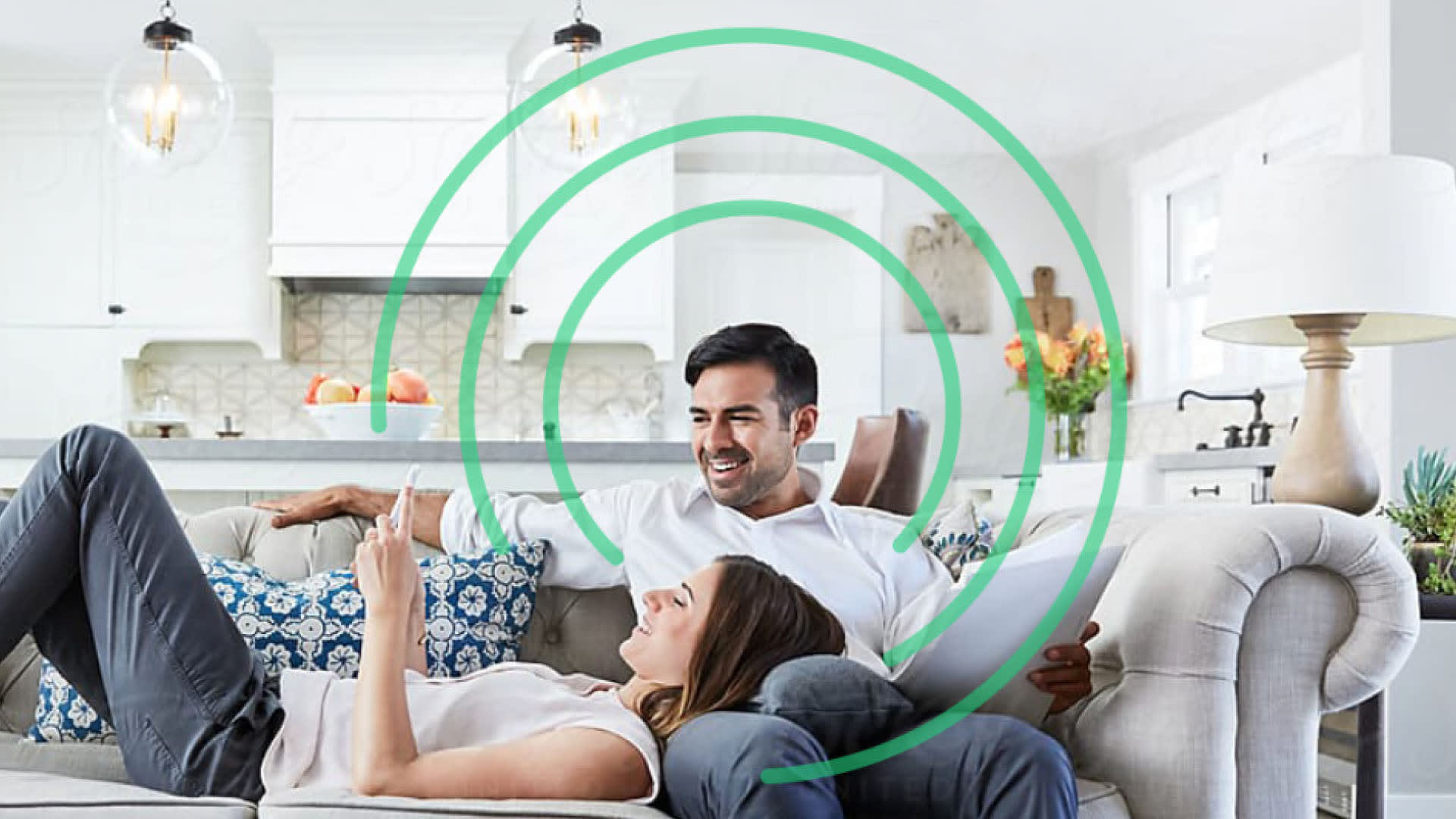 Young couple lounging on the couch with a tablet.