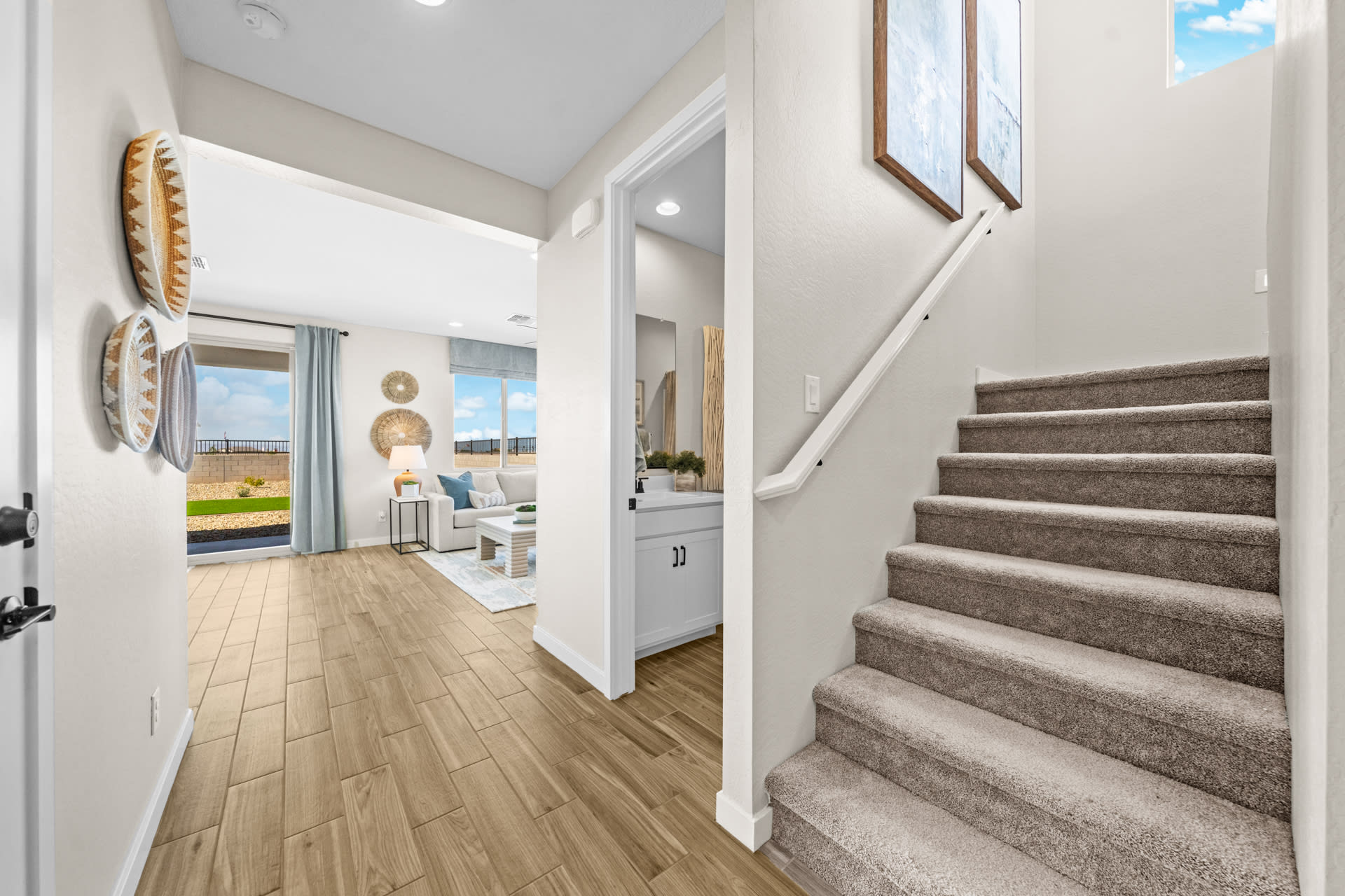 Staircase, Bathroom 3 & Entry into Great Room | Skyline Floorplan | Elara at Moonlight | New Homes in Maricopa, AZ by Landsea Homes