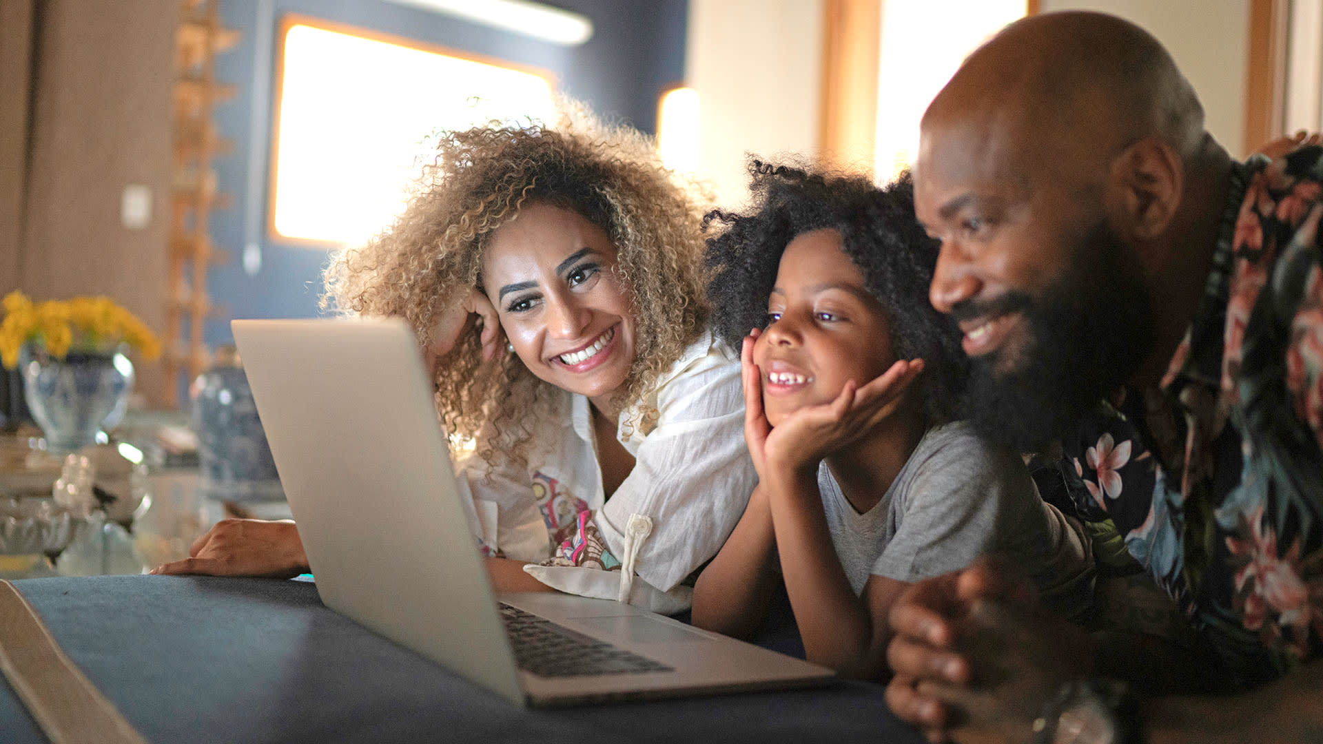 family looking at a laptop together